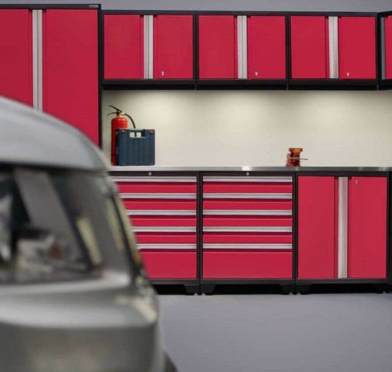 red steel garage cabinetry on a matte finish gray floor