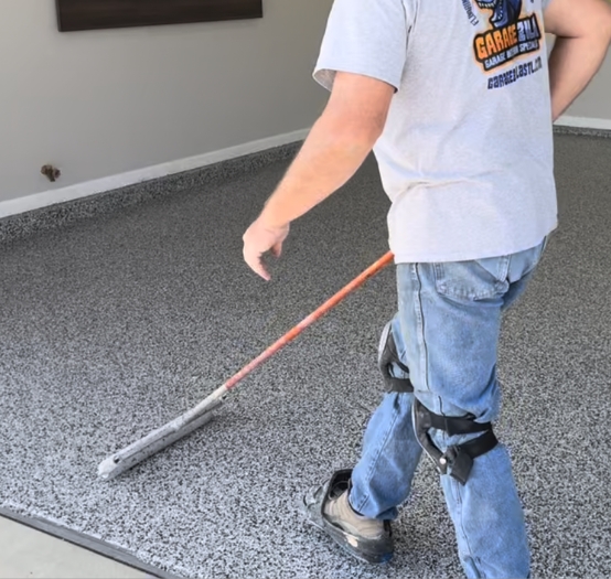 worker putting a final polish on a freshly laid polyaspartic floor