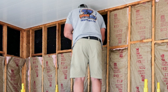 GarageZilla pro installing fiberglass insulation in garage walls