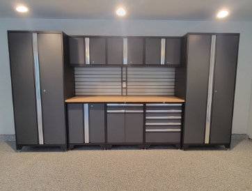 a newly renovated garage with polyaspartic floor and modular steel cabinets