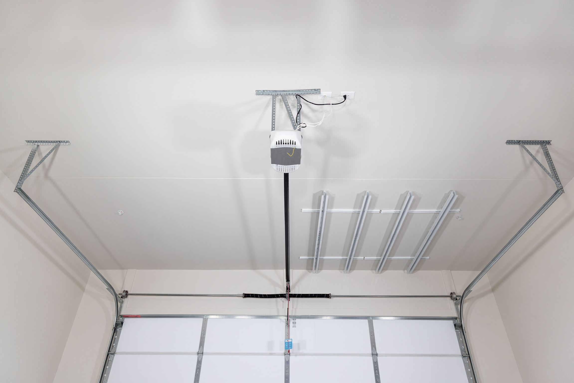 Storage planned around garage door tracks and opener